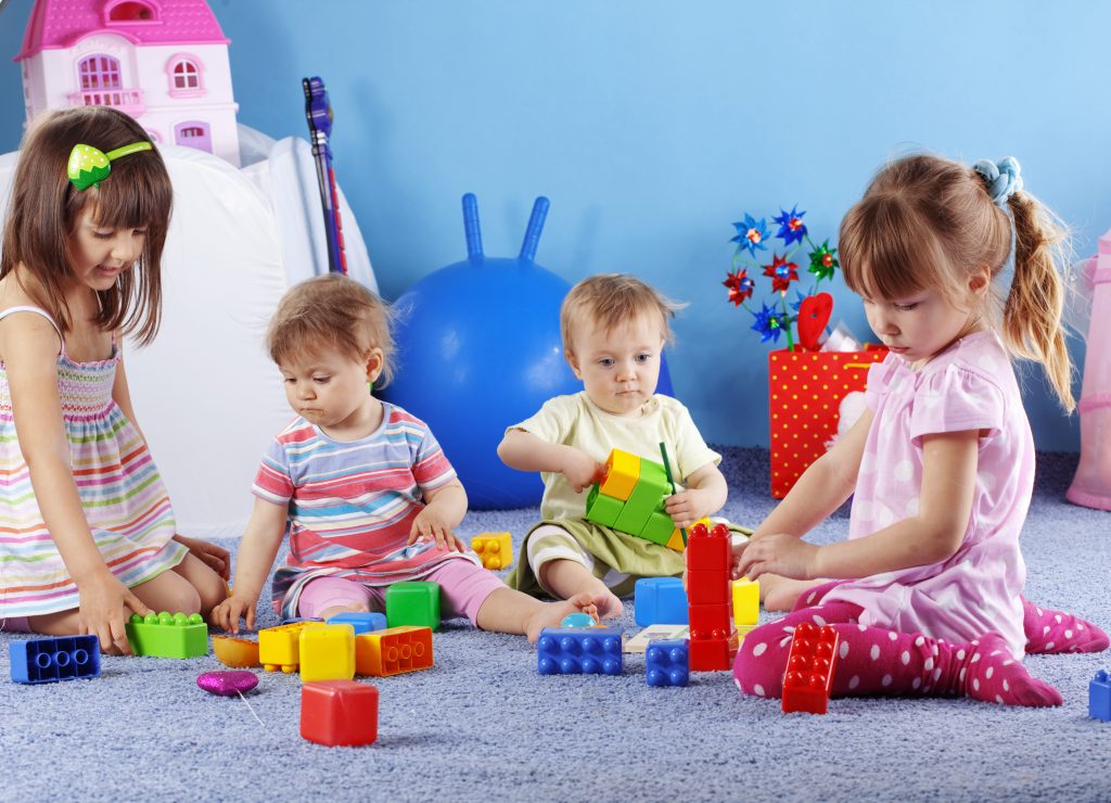 4 children playing blocks at a daycare